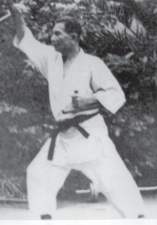 Historical photograph of Shinken Taira practicing kobudo